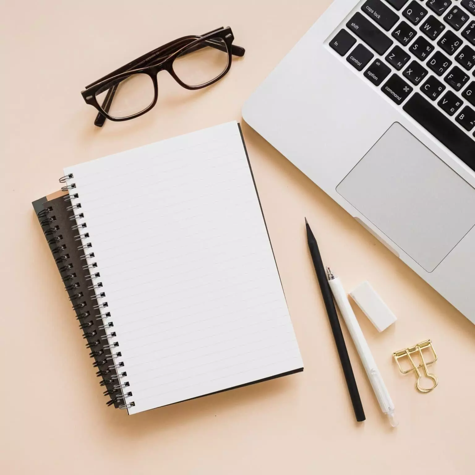 overhead-view-stationeries-laptop-beige-background